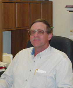 Ken Hood, Assessor, sitting in his office chair