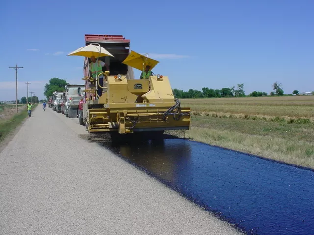 A chipping and sealing machine working on the road.